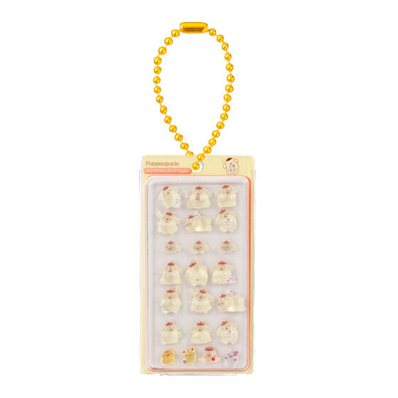 サンリオキャラクターズ ボンボンドロップミニチュアチャームのポムポムプリン。黄色の台紙にプリンの様々な表情のチャームが詰め込まれ、ゴールドのボールチェーンが付属した可愛らしいデザイン。